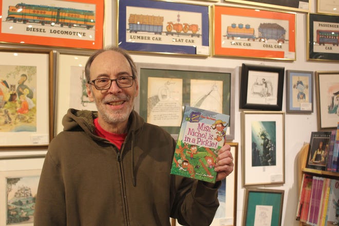 Dan Gutman, a children's book author, holds up the recently published "Miss Nichol Is in a Pickle!"