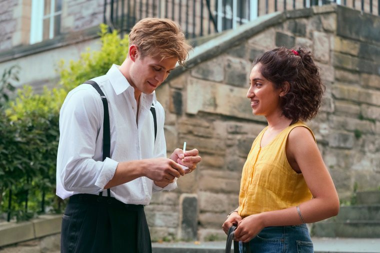 This image released by Netflix shows Ambika Mod, right, and Leo Woodall in a scene from the mini-series "One Day." (Netflix via AP)