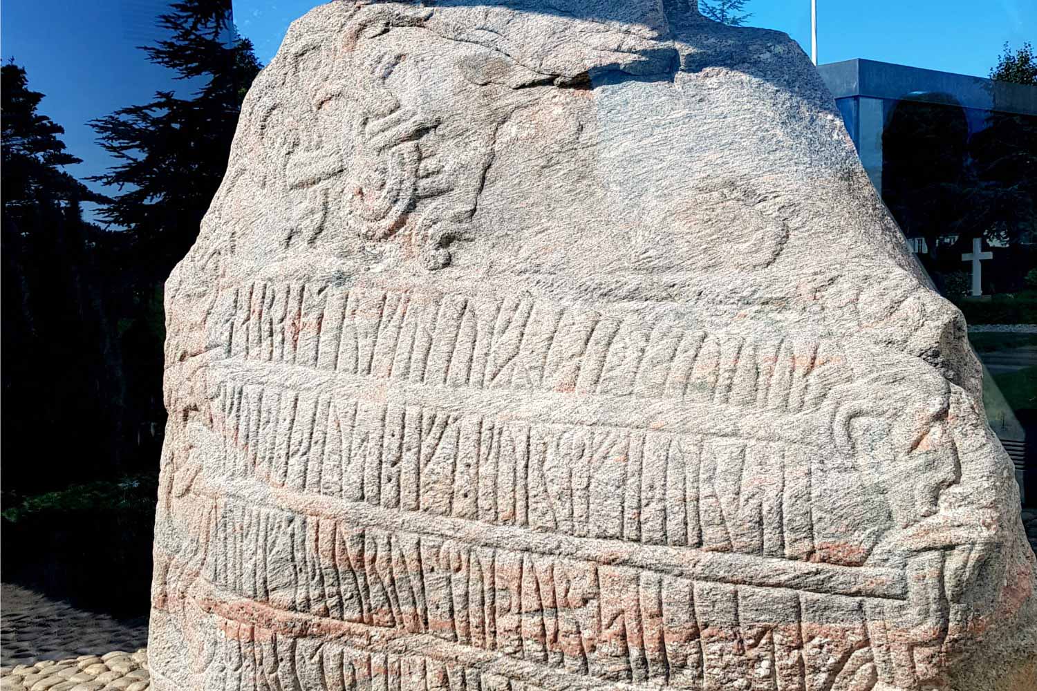 Ancient stone at Kongernes Jelling in Jutland, Denmark with rune markings on - the best kids books about denmark