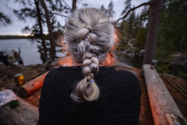 A woman looks at a fire