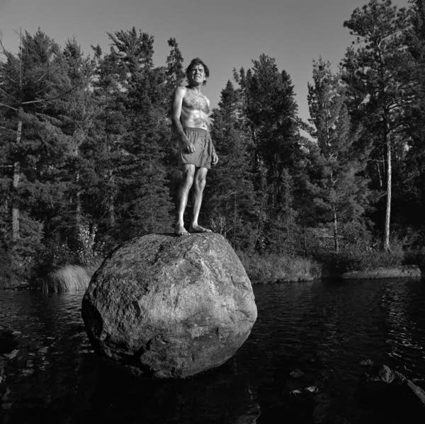 A man about to jump of a large rock