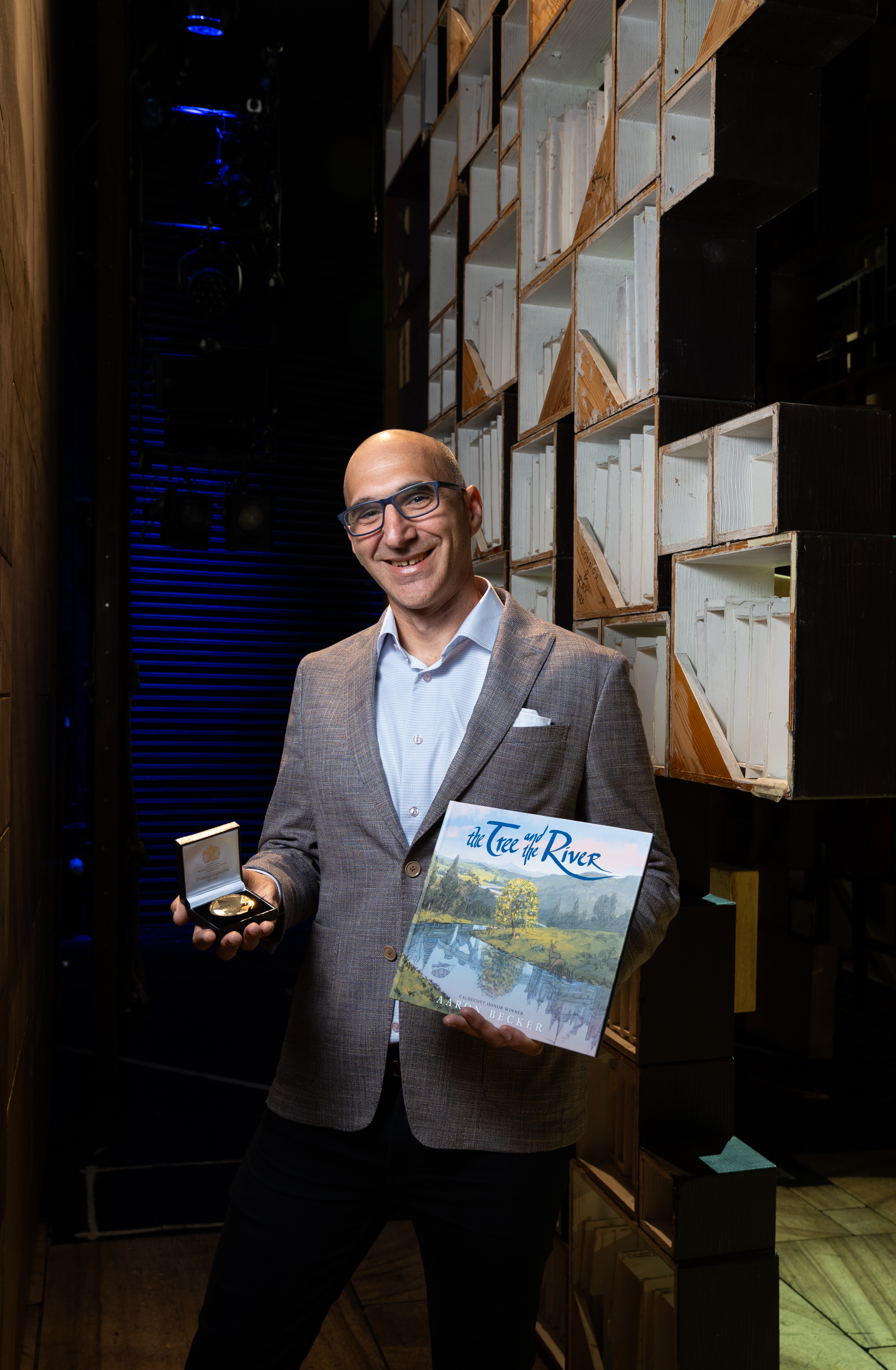 Aaron Becker with his book The Tree And The River and the Yoto Carnegie medal for illustration