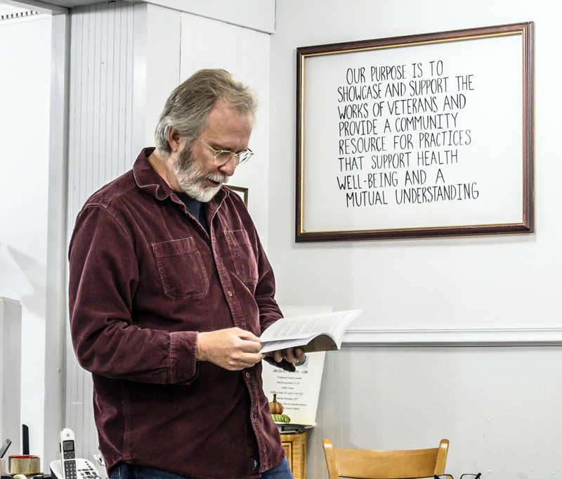 Ron Capps reviews information from his book Writing War during a veterans writing workshop at The Peace Gallery in Damariscotta on Oct. 18. Capps, who served as both a soldier and a foreign service officer in countries like Kosovo, Rwanda, and Afghanistan, founded the Veterans Writing Project, a nonprofit organization that supports writing workshops around the country. (Bisi Cameron Yee, LCN)