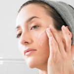 Woman putting on face cream