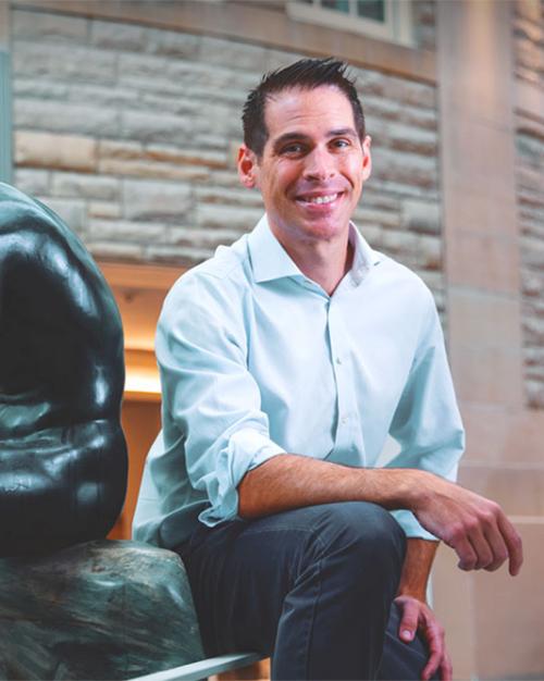 Person posing next to a statue