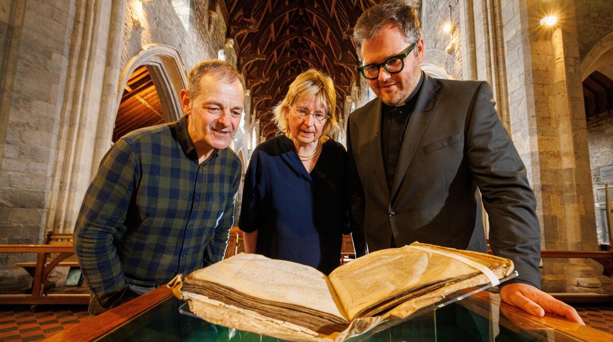Conservation consultant John Gillis with RCB chief librarian Susan Hood as she hands The Red Book of Ossory into the care of the Dean of Ossory, Very Rev Stephen Farrell. Picture: Dylan Vaughan Conservation consultant John Gillis with RCB chief librarian Susan Hood as she hands The Red Book of Ossory into the care of the Dean of Ossory, Very Rev Stephen Farrell. Picture: Dylan Vaughan