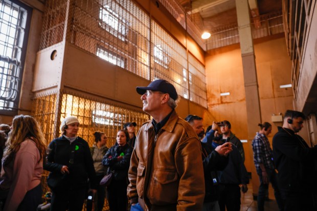 Mike Lynch, author of Alcatraz: The Last Escape, walks along D-Block at Alcatraz in San Francisco, Calif., on Wednesday, April 3, 2024. D-Block was where prisoners with behavioral problems were sent to solitary confinement. (Shae Hammond/Bay Area News Group)