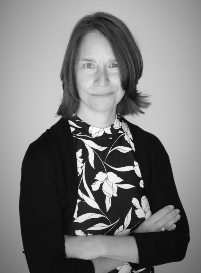 A black and white portrait headshot shows Brock Professor Nancy Taber looking at the camera and crossing her arms.