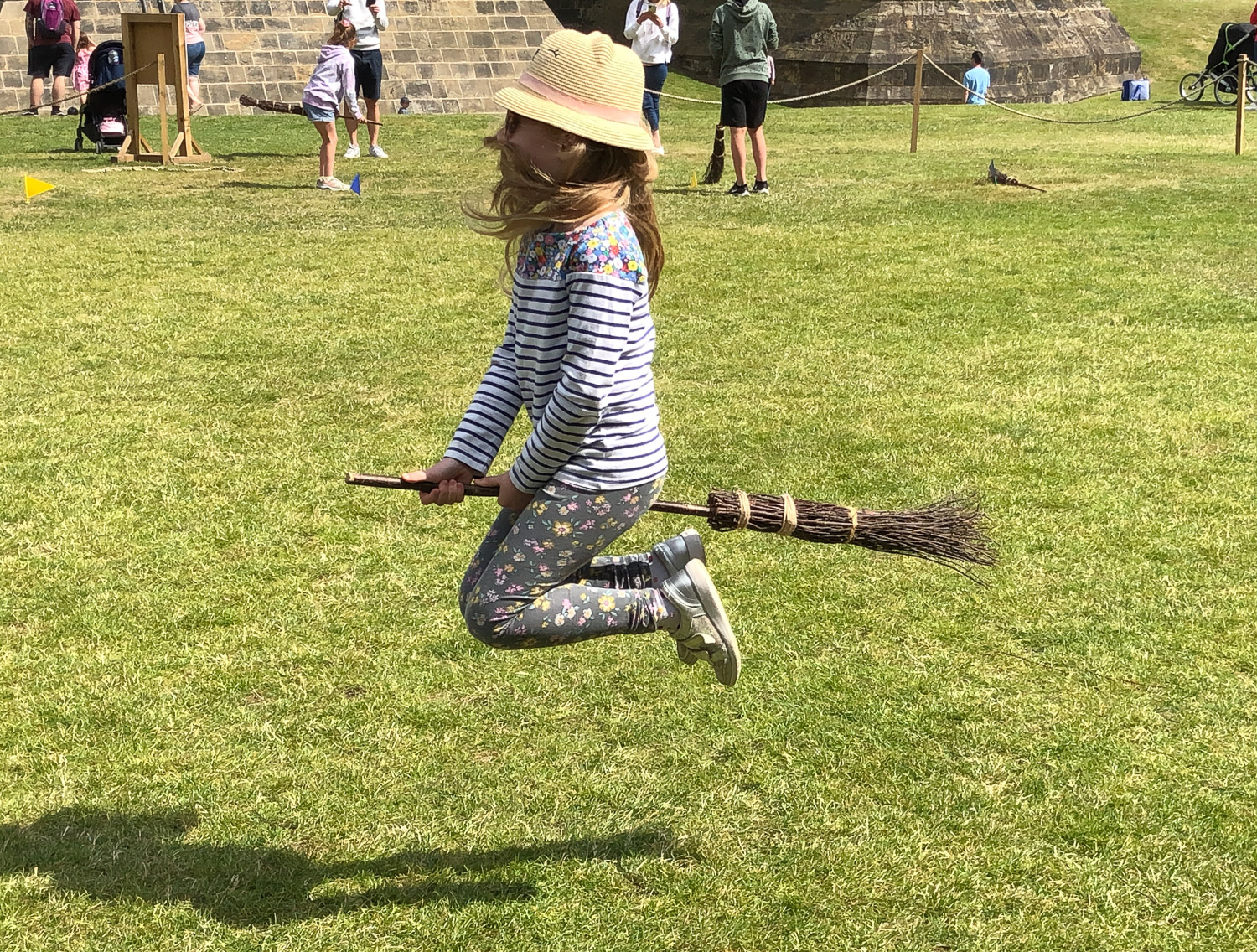 My daughter suspended in mid air on her broomstick with her hair whipped across her face - one of the filming locations for Harry Potter, it's a fantastic day out for kids who love reading